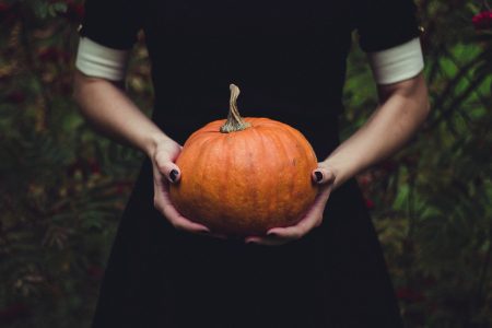 woman holding orange pumpkin - infertility and fall favorite recipes